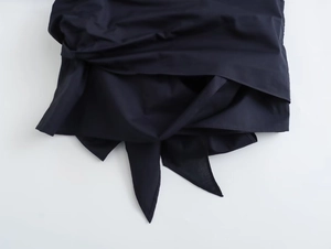 Close-up of the irregular tie-knot hem on this navy blue poplin shirt fabric detail
