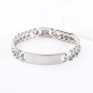Close-up of polished stainless steel curb chain bracelet with blank rectangular ID plate