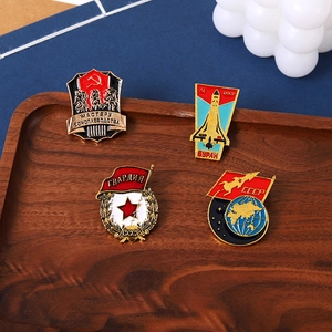 Detail of vintage Soviet Union CCCP metal enamel pins with red star on wooden tray