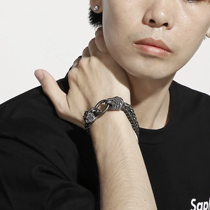 Detail of vintage lion head double-strand stainless steel bracelet on a male model