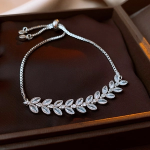 Detail of leaf-shaped zircon bracelet in silver finish with adjustable slider in a box