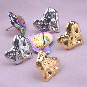 Detail of hammered texture heart earrings in gold silver and rainbow finishes