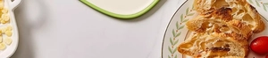 Detail of food-grade antibacterial cutting board with fresh baguette and marble background