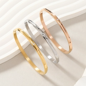 Three-color minimalist bangle set in gold silver and rose gold with diamond accents