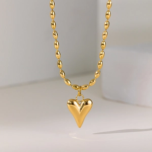 Beaded golden necklace with a French style heart pendant featuring natural pearl