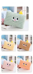 Close-up of cute cartoon hand warmer pillows with striped plush texture in five colors