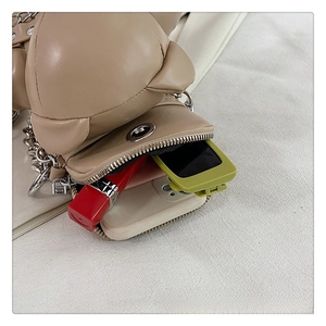 Detail view of the beige bear-shaped PU crossbody bag showing interior storage space