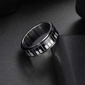Rotating stainless steel anxiety ring for men featuring a black and white piano key pattern