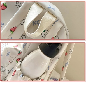Detail of reinforced top handle and elastic side water bottle pocket on strawberry backpack