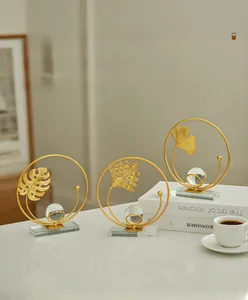 Three-piece gold metal leaf ornaments with crystal balls on clear bases for home decor