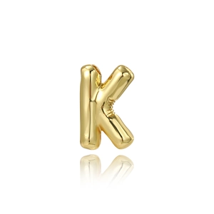Close-up of polished 18K gold plated capital letter K pendant with reflective mirror finish