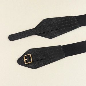 Detailed macro view of black crocodile pattern leather texture on elastic waist belt