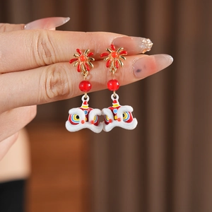 Detailed macro view of lion dance earring featuring enamel finish and velvet details