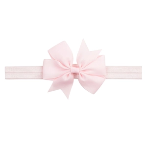 Detail of baby headband with pink grosgrain ribbon bow and soft elastic band