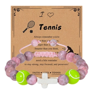 Pink zebra stone tennis bracelet with green ball beads and white cross on a gift card