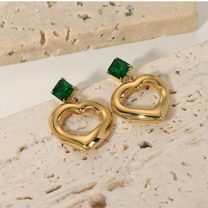 Gold heart drop earrings with green square zircon stone on a textured stone base