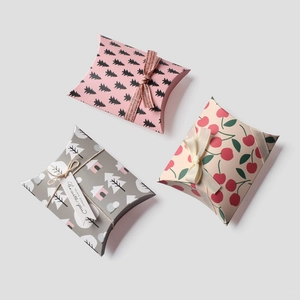 Three assorted mini pillow boxes with cute patterns and ribbons for gift packaging