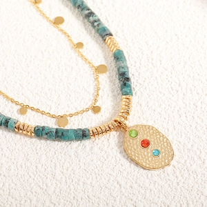 Double-layer bohemian necklace with turquoise beads and hammered gold pendant with gems