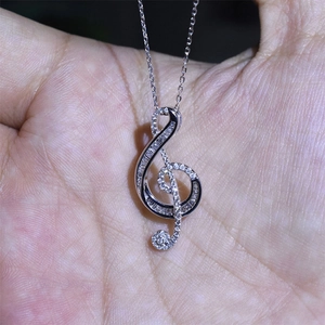 Elegant treble clef musical note pendant necklace with sparkling pavé cubic zirconia