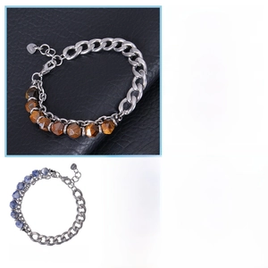 Detail of men's stainless steel Cuban chain bracelet with natural tiger eye beads