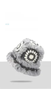Detail of grey plush faux fur bucket hat with handmade white crochet sunflower embroidery