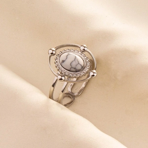 Detailed macro view of vintage silver bohemian ring with oval white turquoise stone inlay