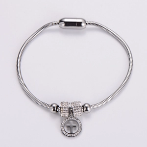 Silver snake chain bracelet featuring a magnetic clasp and crystal cross pendant charm