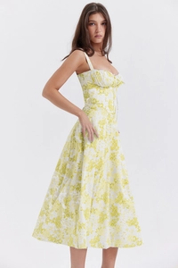 Detail of white midi dress with yellow floral prints and elegant corset waistline