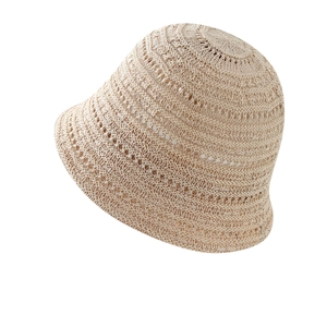 Women's minimalist hollow woven straw bucket hat for summer sun protection in beige color
