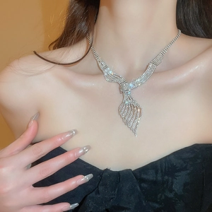 Detailed view of leaf shaped silver necklace with sparkling diamonds on female model