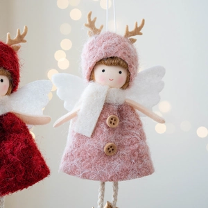 Pink plush reindeer angel girl Christmas ornament with soft bokeh background