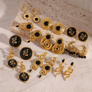 Macro shot of vintage gold stainless steel earrings with black onyx on stone base