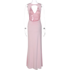Detail of pink backless dress with ruched waist and soft fabric texture on white background