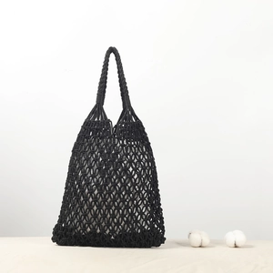 Handmade black woven cotton rope bucket bag with hollow design and rustic pastoral style