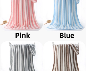 Detail view of thick coral fleece bath towels in pink, blue, gray and brown stripes