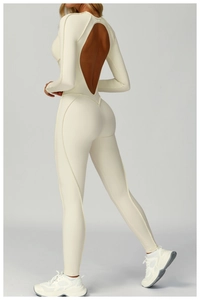 Detailed back view of a cream ribbed yoga jumpsuit featuring a water-drop cutout design