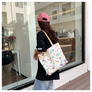 Lifestyle shot of large canvas tote bag with colorful abstract geometric prints