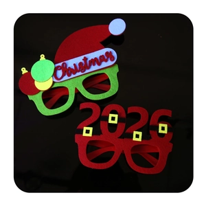 Detail view of 2026 Santa belt and Christmas hat felt party glasses on black background