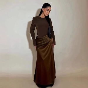 Detail of the elegant ruched waist and satin skirt of this slim dark brown maxi dress