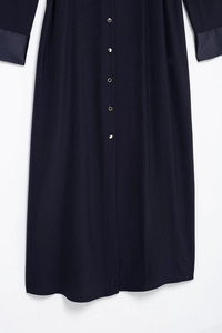 Detailed view of navy cargo dress with shoulder button accents and contrast cuffs
