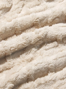 Close-up of beige thick plush fleece fabric showing soft texture and thermal lining