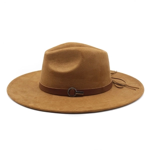 Detail view of camel faux suede fedora hat featuring a brown belt with metal buckle and fringe