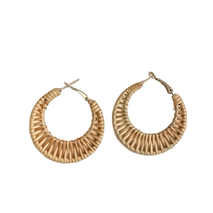 Retro C-shaped woven rattan drop earrings with golden metal studs on white background