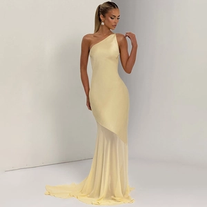Detail of elegant one-shoulder yellow evening dress with satin bodice and flowing long skirt