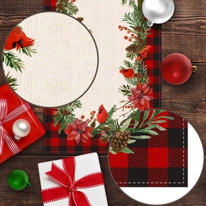 Close-up of Christmas table runner with festive birds, pine cones, and red plaid borders