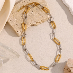 Two-tone 18K gold and silver stainless steel paperclip chain necklace on stone base