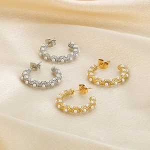 Vintage stainless steel C-shaped earrings with pearls and gold finish on satin