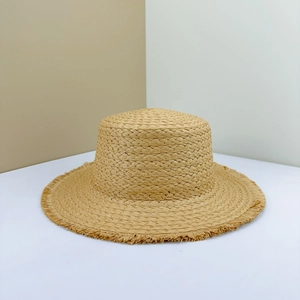 Flat top straw sun hat with wide frayed brim and natural weave texture for summer beach