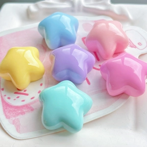 Flat lay of colorful resin star charms for DIY crafts and phone case decoration