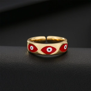 Adjustable gold plated evil eye ring with red enamel finish on leather display stand